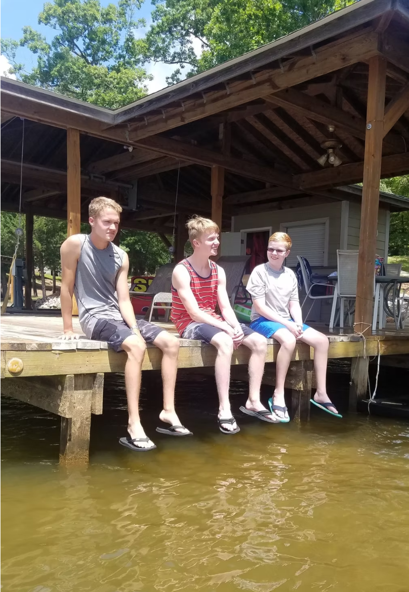 Our sons when older posing on the dock at the lake